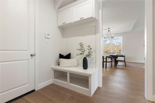 3223 Tamy Ln, Brenham, TX 77833 - mudroom with a chandelier, light wood finished floors, and baseboards