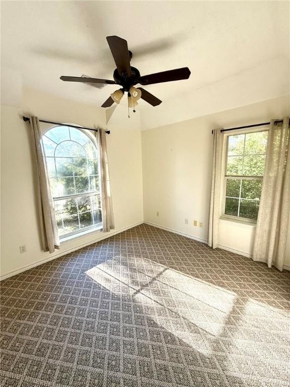 carpeted empty room with ceiling fan