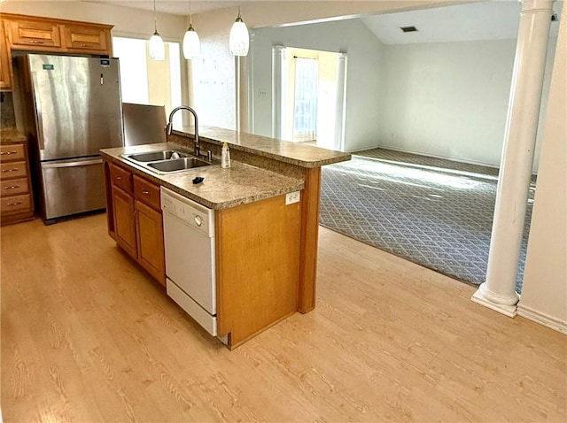 kitchen featuring dishwasher, stainless steel fridge, sink, and decorative columns