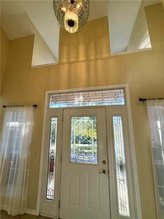 foyer entrance featuring a notable chandelier