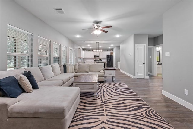 8729 Nathan Dr, Waller, TX 77484 - living area with ceiling fan, dark wood-style flooring, and a chandelier