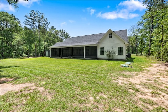 8729 Nathan Dr, Waller, TX 77484 - rear view of property with a sunroom, a yard, and a shingled roof