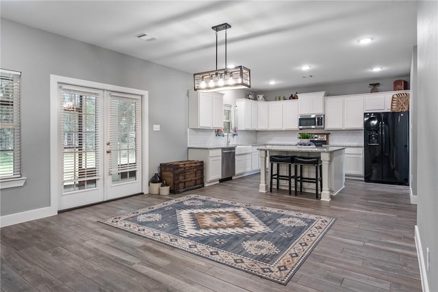 8729 Nathan Dr, Waller, TX 77484 - kitchen with appliances with stainless steel finishes, backsplash, plenty of natural light, and recessed lighting