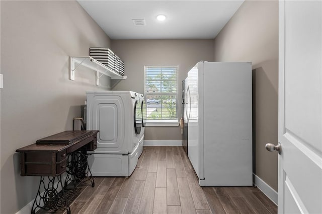 8729 Nathan Dr, Waller, TX 77484 - washroom with washer / clothes dryer and wood finished floors