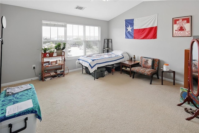 carpeted bedroom with lofted ceiling