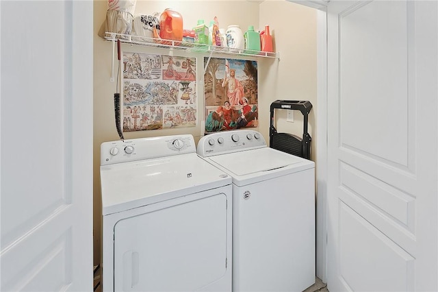 clothes washing area with washing machine and dryer