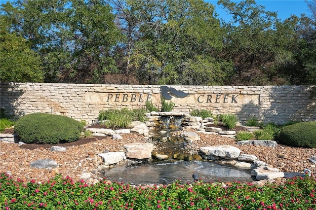 904 Plainfield Ct, College Station, TX 77845 - community sign with a garden pond