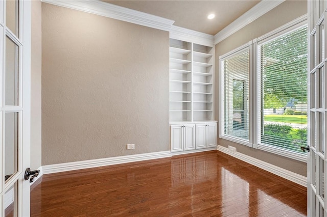 904 Plainfield Ct, College Station, TX 77845 - empty room with wood finished floors, built in shelves, ornamental molding, a textured wall, and baseboards