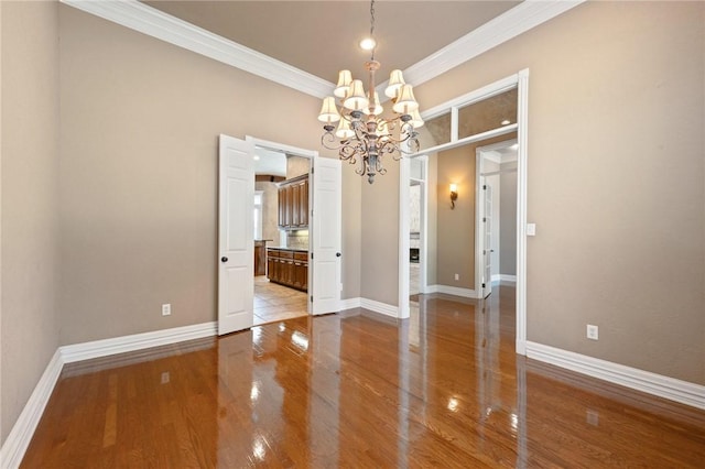 904 Plainfield Ct, College Station, TX 77845 - empty room with a chandelier, crown molding, wood finished floors, and baseboards
