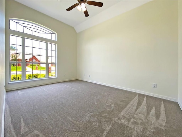 carpeted empty room with vaulted ceiling and ceiling fan