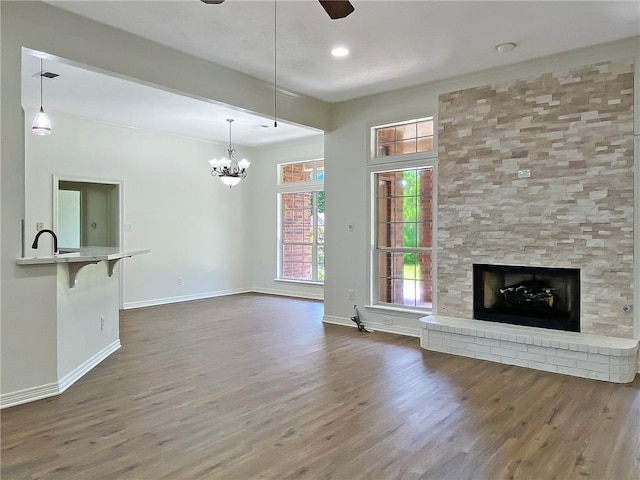 unfurnished living room featuring dark wood-style flooring and baseboards