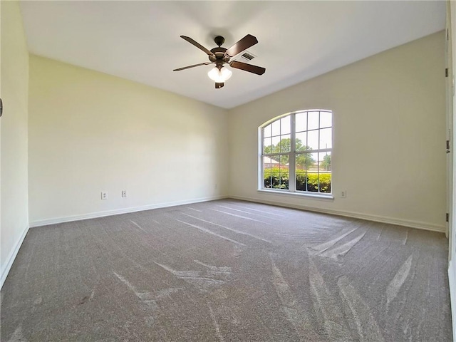 carpeted spare room with ceiling fan