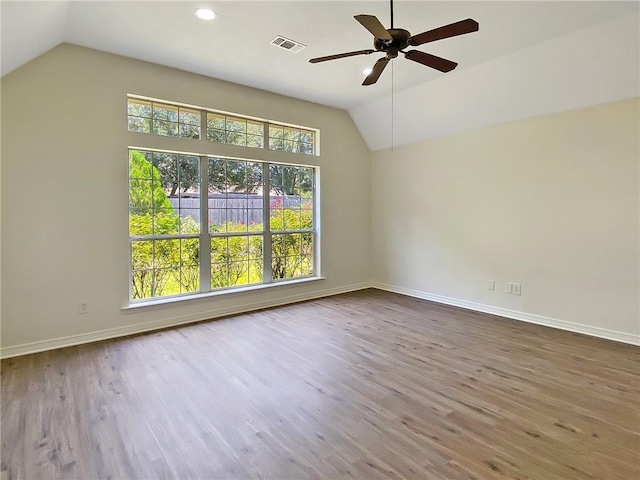 empty room featuring lofted ceiling, wood-type flooring, and ceiling fan