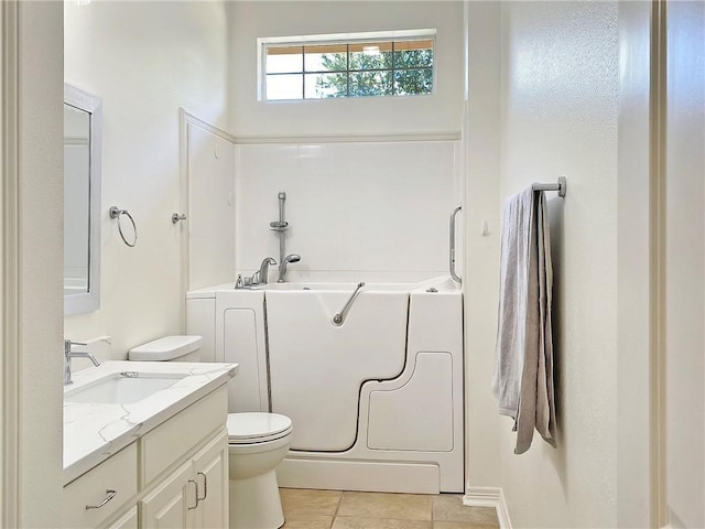 bathroom with vanity, toilet, tile patterned flooring, and a bathtub