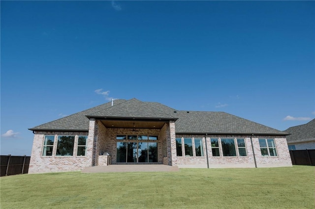 back of house featuring a patio area and a lawn