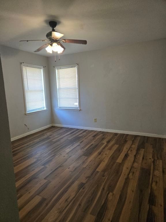 empty room featuring ceiling fan and dark hardwood / wood-style floors