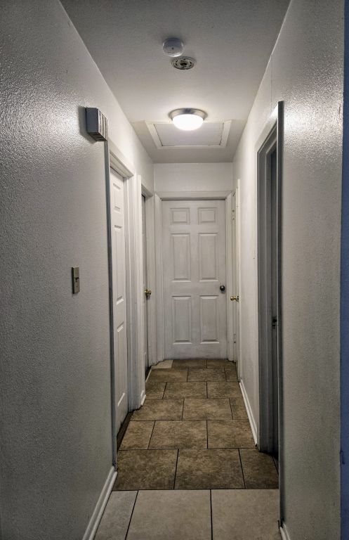 900 E 27th St, Bryan, TX 77803 - hallway with tile patterned flooring and baseboards