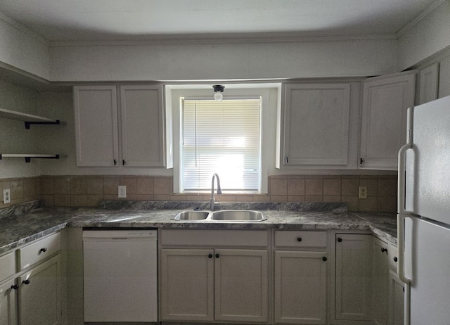 kitchen with white cabinetry, decorative backsplash, sink, and white appliances