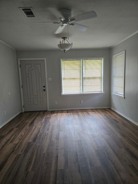 entryway featuring ceiling fan, dark hardwood / wood-style flooring, and ornamental molding