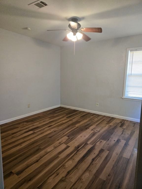 empty room featuring ceiling fan and dark wood-type flooring