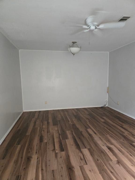 900 E 27th St, Bryan, TX 77803 - spare room with wood finished floors, ceiling fan, and baseboards