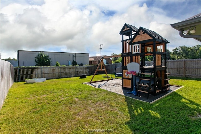 view of playground featuring a yard and a patio