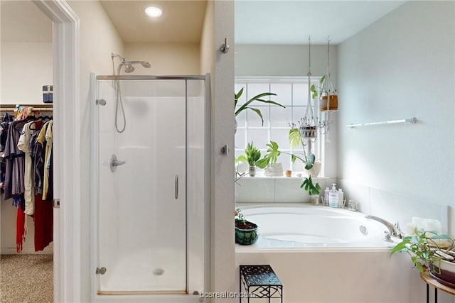 bathroom with separate shower and tub