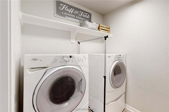 clothes washing area featuring separate washer and dryer