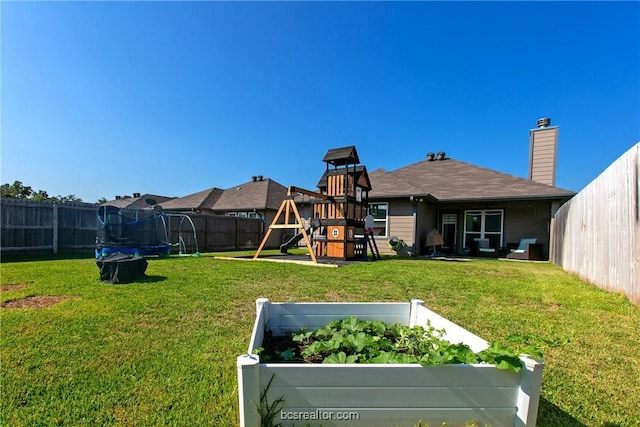 view of yard featuring a playground and a trampoline