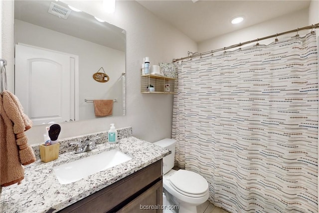 bathroom with vanity, a shower with shower curtain, and toilet