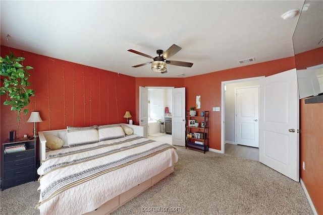 carpeted bedroom featuring ensuite bathroom and ceiling fan