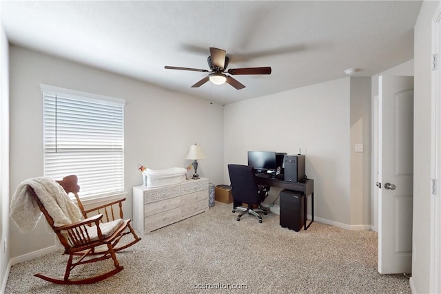 carpeted office space featuring ceiling fan