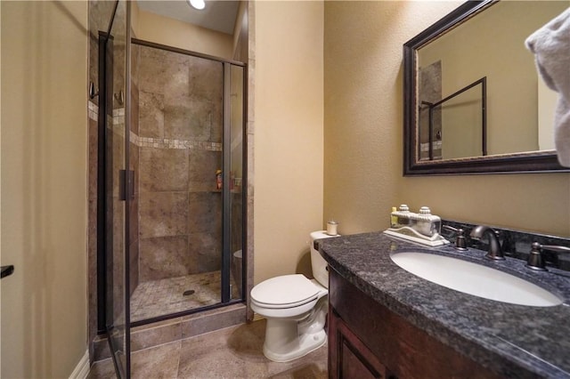 bathroom featuring vanity, toilet, and a shower with door