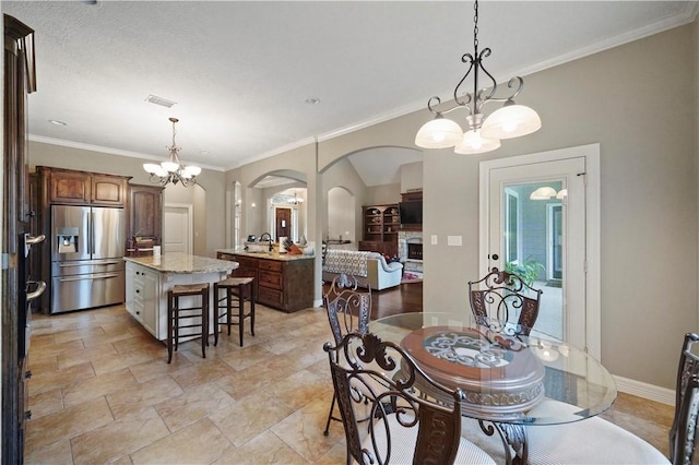 dining area featuring a chandelier and crown molding