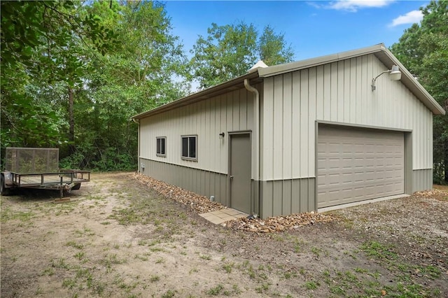 view of side of home featuring a garage and an outdoor structure