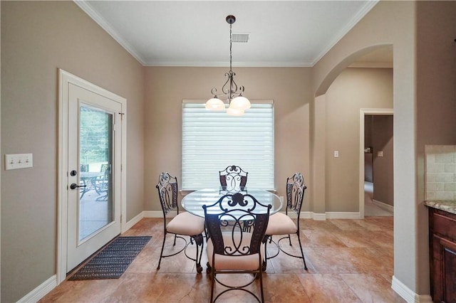 dining space with a chandelier and ornamental molding