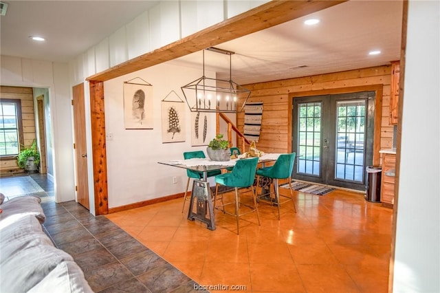 tiled dining space featuring a wealth of natural light and french doors