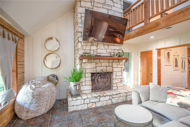 living room featuring lofted ceiling and a fireplace