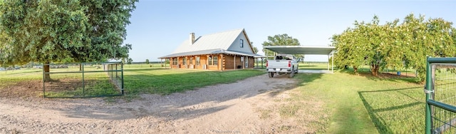 view of yard featuring a carport and an outdoor structure