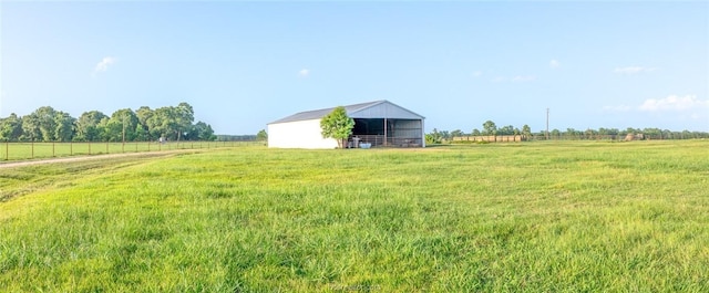 view of yard with a rural view and an outdoor structure