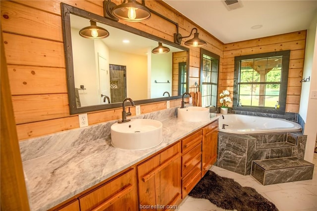 bathroom featuring vanity and a relaxing tiled tub