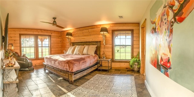 bedroom featuring multiple windows and ceiling fan