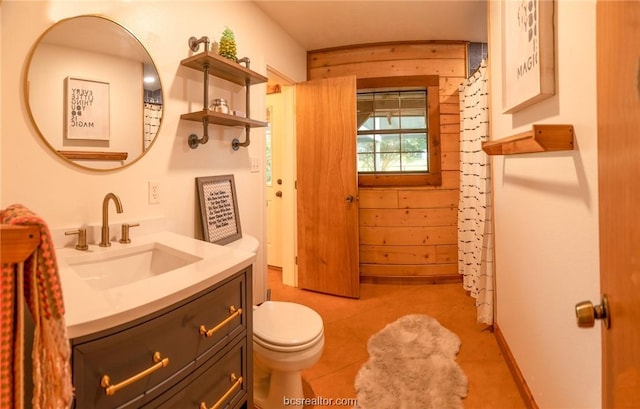 bathroom featuring tile patterned flooring, vanity, and toilet