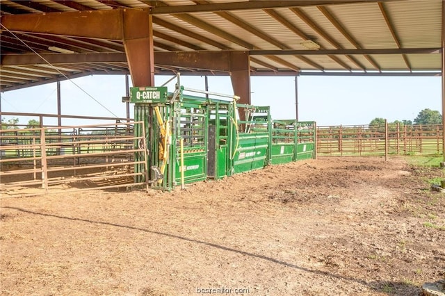 view of horse barn with a rural view