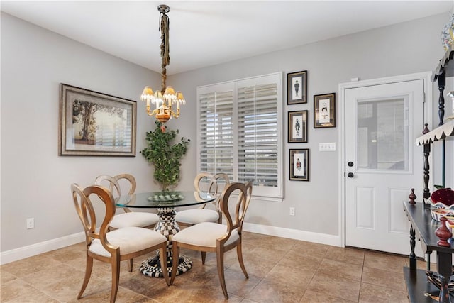 tiled dining room featuring a chandelier