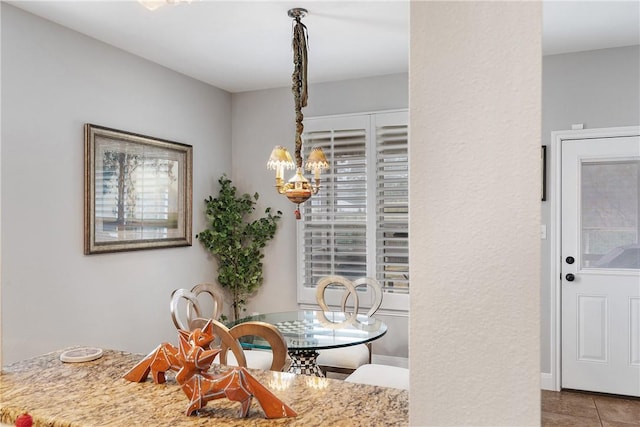 tiled dining space with an inviting chandelier