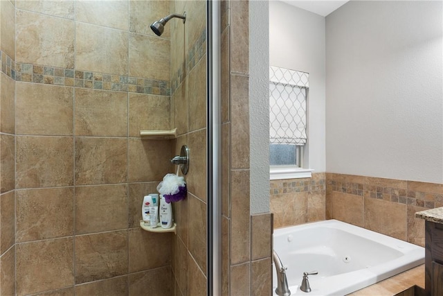 bathroom featuring vanity and shower with separate bathtub