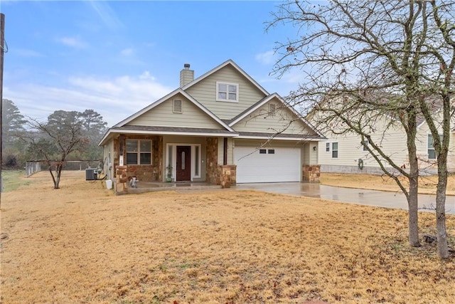 view of front of house featuring a porch, a garage, and central AC unit