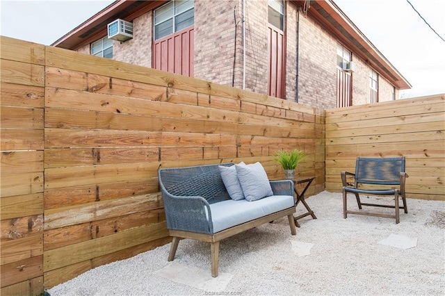 view of patio / terrace with a wall mounted air conditioner