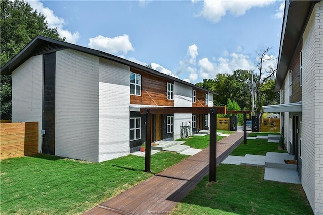 rear view of house featuring a lawn